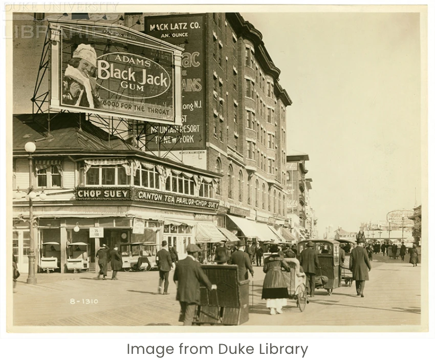 old photo of life on street with large black jack gum billboard